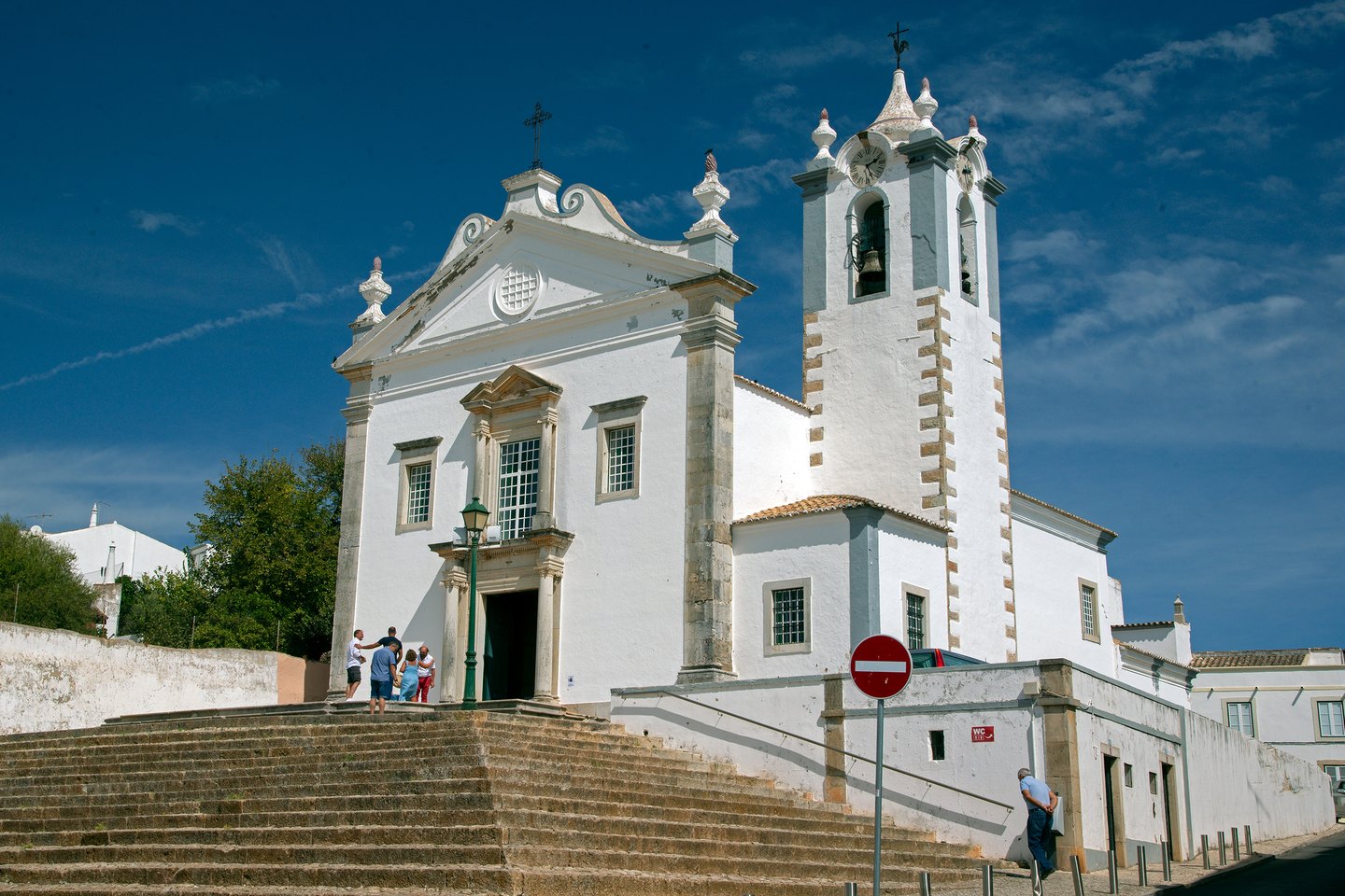 The white parish church of Estoi with its front steps